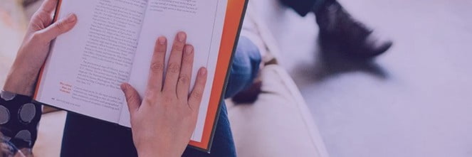 UG Images 318x106-10 person sitting on couch reading book