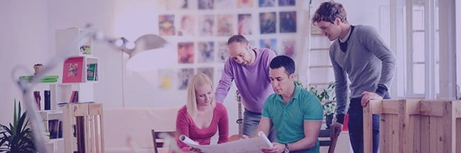 UG Images 318x106-15 colleagues looking at poster