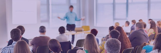 UG Images 318x106-16 man speaking in front of conference room to audience
