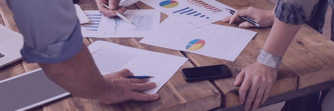 UG Images 318x106-19 colleagues going over graphs & paperwork