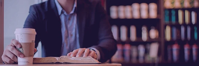 UG Images 318x106-2 businessman drinking coffee reading book