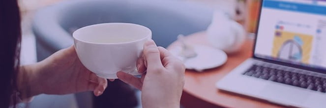 UG Images 318x106-22 woman holding cup in front of laptop