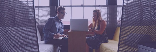 UG Images 318x106-23 male and female colleague sitting looking at laptop