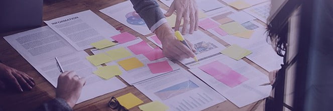 UG Images 318x106-28 two people going over highlighting and marking paperwork