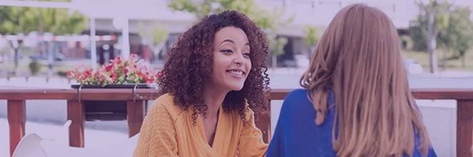 UG Images 318x106-29 two women sitting outside talking to each other