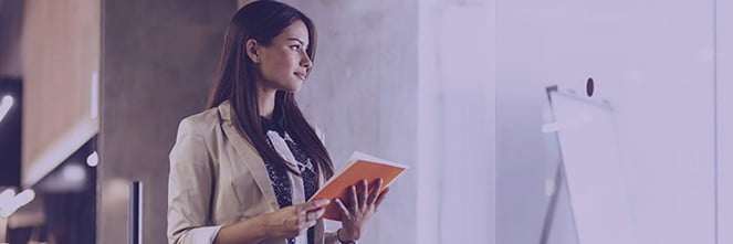 UG Images 318x106-39 woman holding booklet looking into the distance