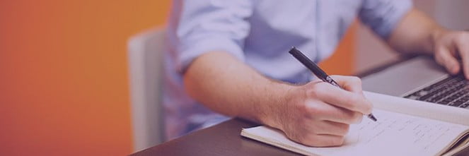 UG Images 318x106-43 man writing notes in notebook