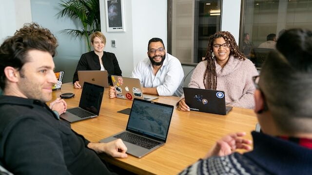Office workers sitting around the table at a respectful workplace